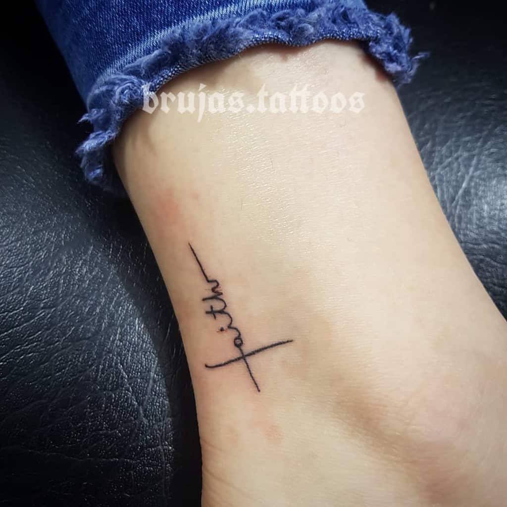 A minimalist "faith" tattoo graces the ankle, elegantly intertwined with a delicate cross, symbolizing strength and spirituality in harmony