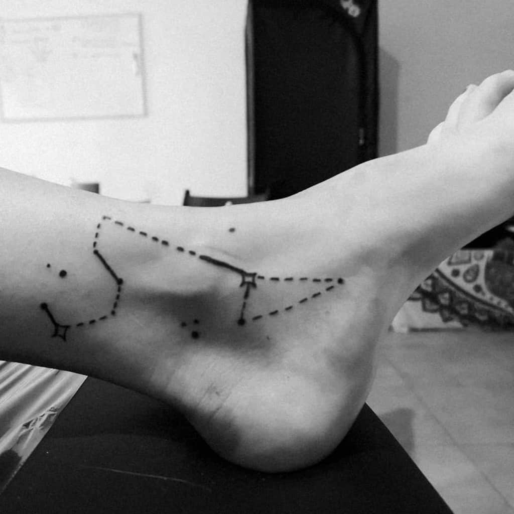Leo constellation tattoo on ankle with fine dotted lines and stars, symbolizing strength and confidence.