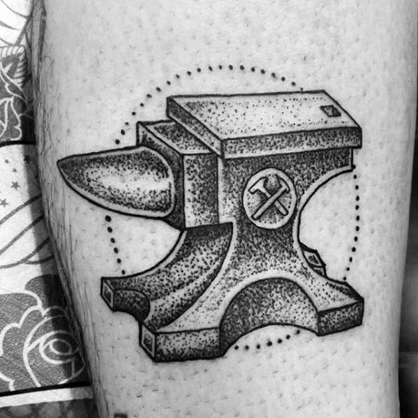 Black and grey dotwork anvil tattoo with a hammer and wrench symbol, surrounded by a dotted circular frame for added detail.