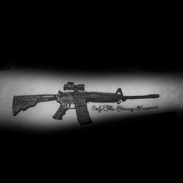 Black and grey AR-15 tattoo on the forearm with the phrase "Only the Strong Survive," symbolizing resilience, strength, and survival mindset.