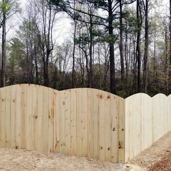 arched unstained wooden fence