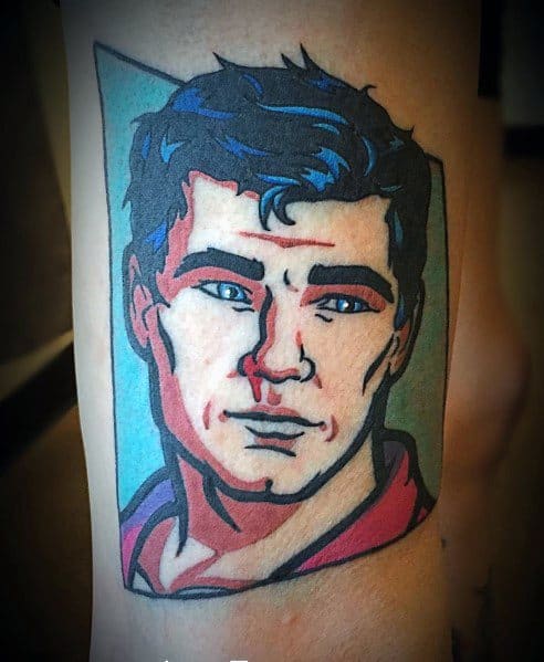 Colorful tattoo of Sterling Archer with blue hair, sharp features, and a vibrant background, capturing the bold style of the animated series.