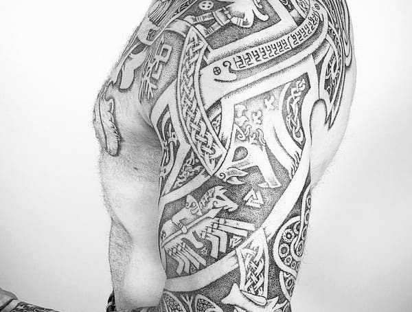 Black and white tattoo sleeve with intricate geometric and tribal designs on a person's arm
