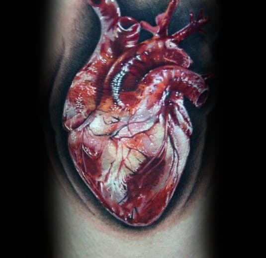 Realistic 3D tattoo of an anatomical heart with vivid details, veins, and shading, creating a striking illusion of depth on the skin.