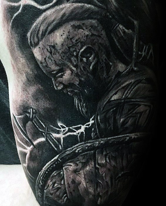 Black and grey tattoo of a Ragnar Lothbrok with a beard holding an axe