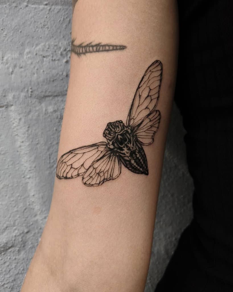 Tattoo of a cicada on an arm
