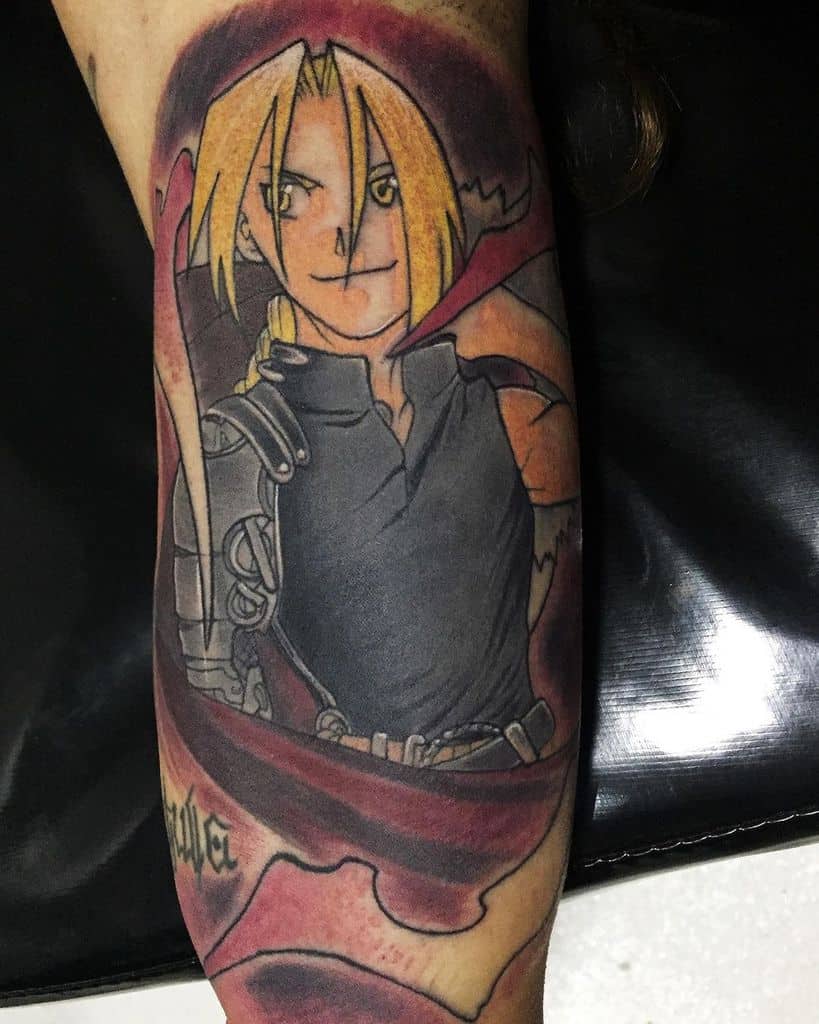 Fullmetal Alchemist tattoo of Edward Elric with his automail arm, red cloak, and determined expression, framed by alchemy-inspired details