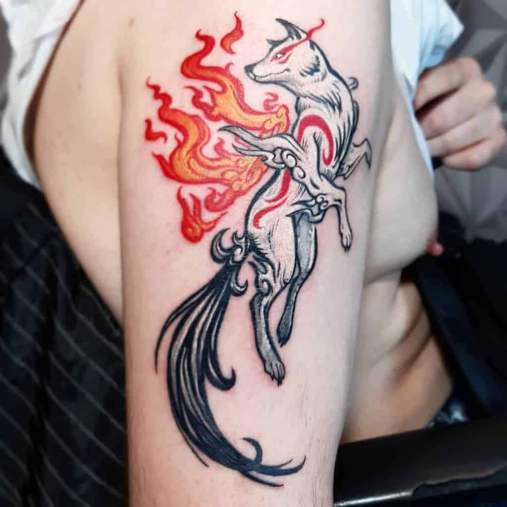 Japanese-style wolf tattoo featuring flowing flames in red and black, placed on the upper arm