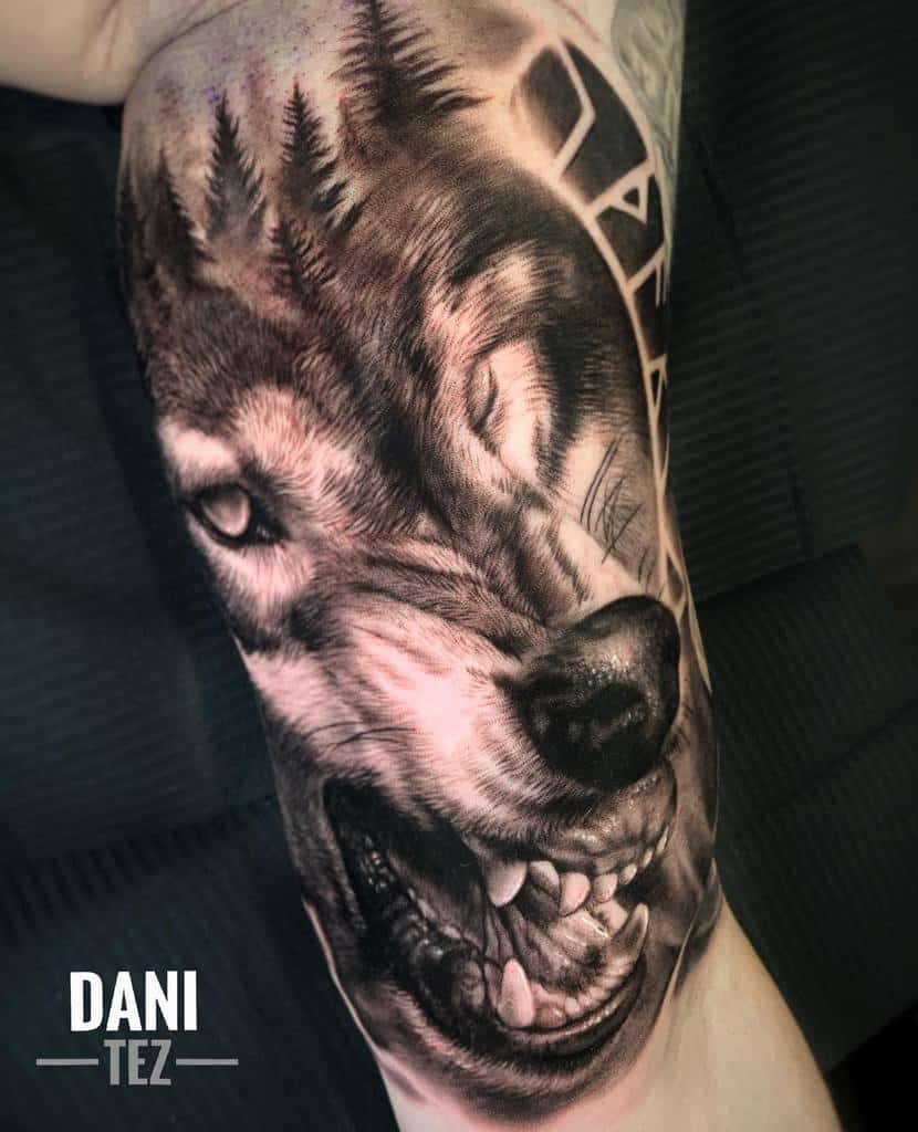 Hyper-realistic Norse wolf tattoo blending forest elements, symbolizing nature's strength and primal instincts