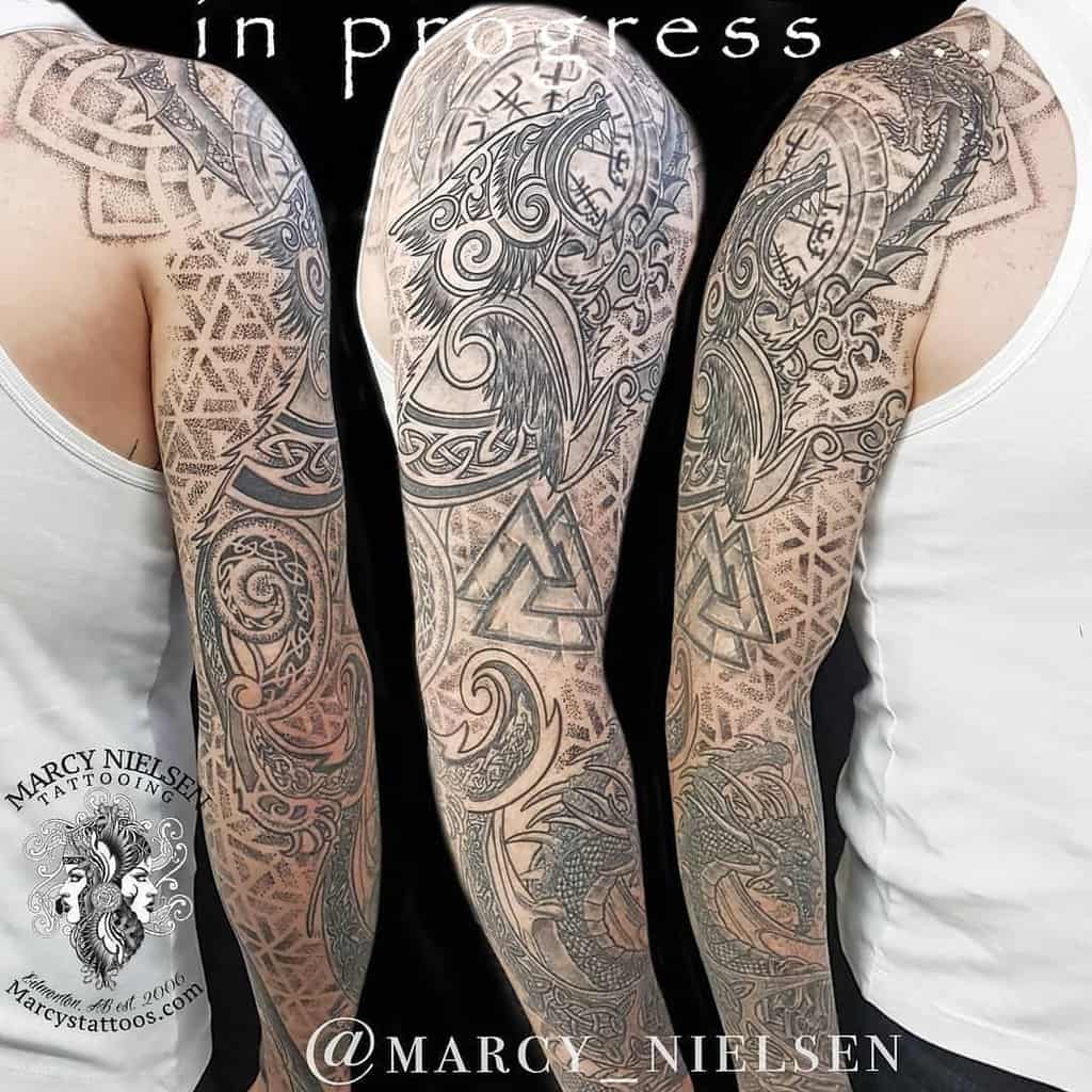Sleeve tattoo featuring intricate Norse mythology designs, including Fenrir, runes, and the Valknut symbol in progress