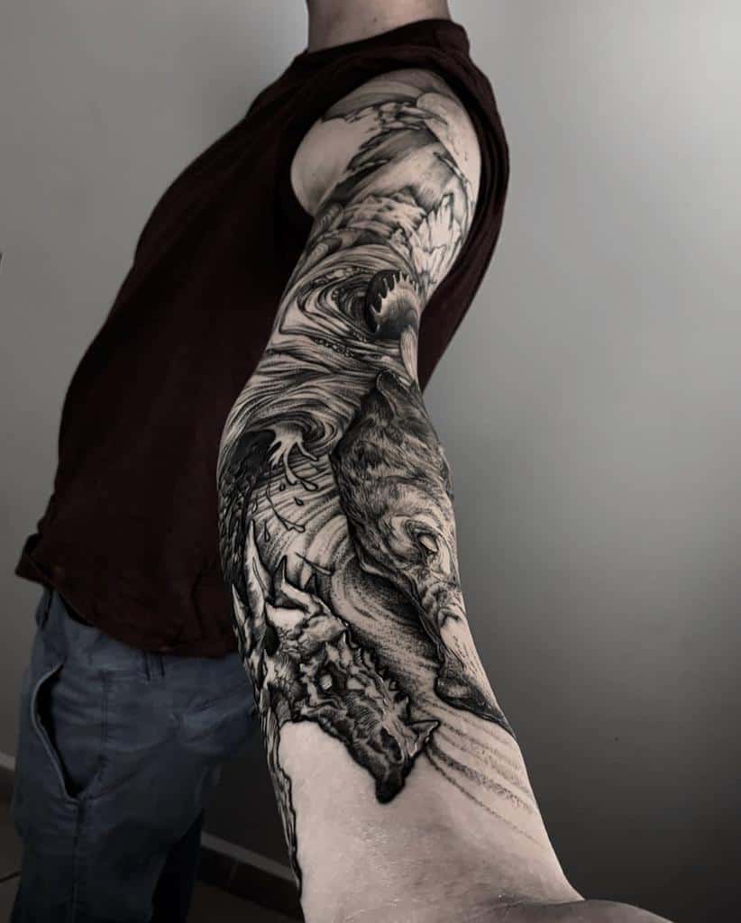 Full sleeve tattoo featuring Fenrir in a dynamic black-and-gray design, showcasing intricate details and Norse mythology elements