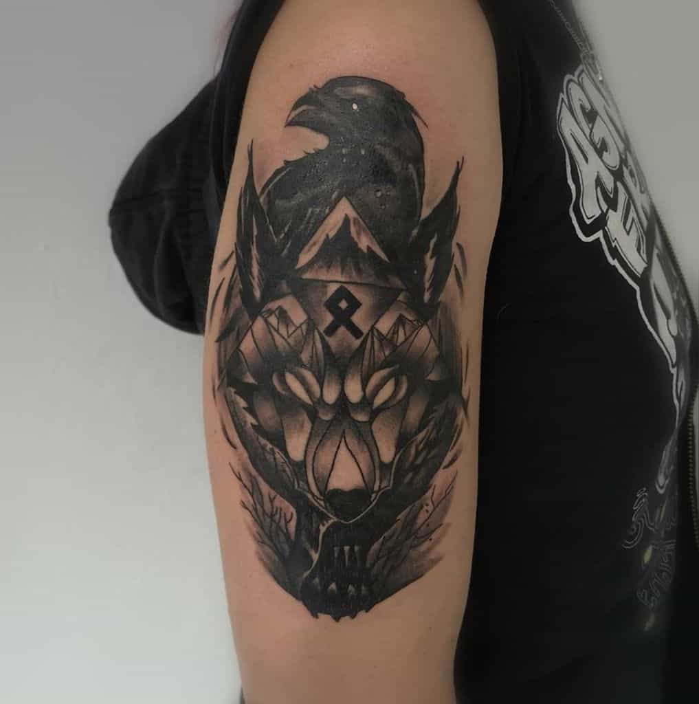 Upper arm tattoo of Fenrir with glowing eyes, a raven, and mountainous details, blending Norse symbolism in a bold design