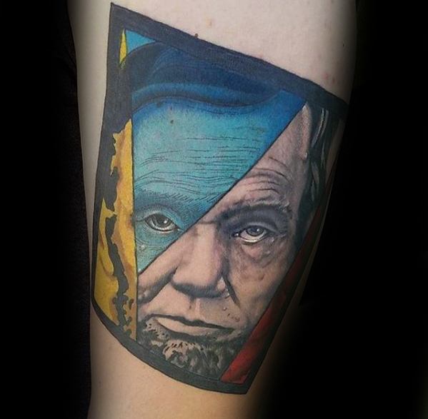 Colorful abstract tattoo of Abraham Lincoln's face divided by geometric shapes
