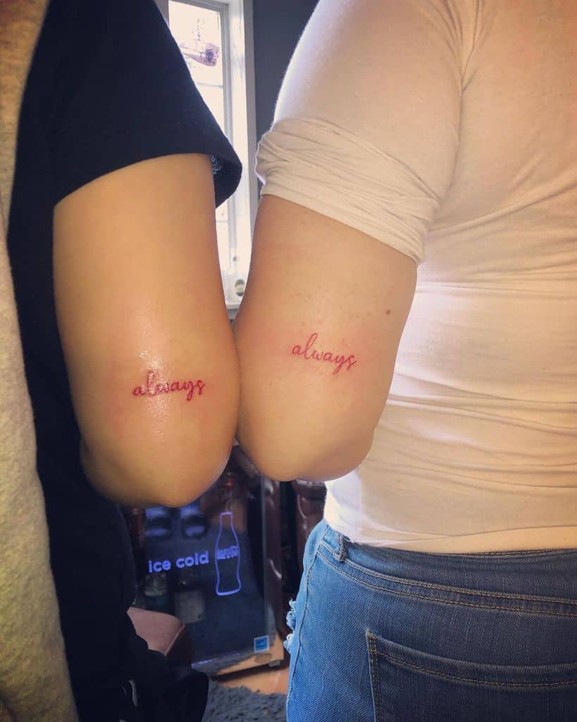 Two people with matching "always" tattoos on their elbows