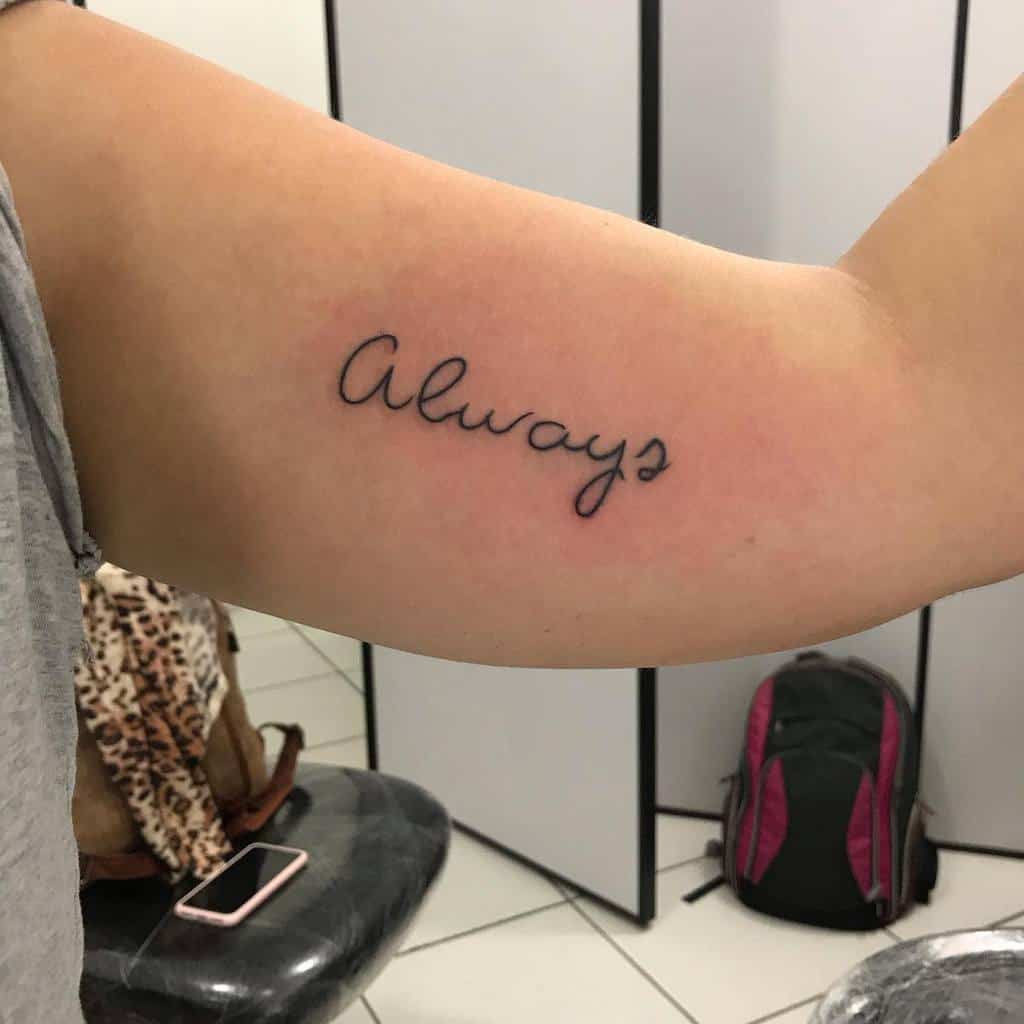 A tattoo of the word "Always" on an inner upper arm