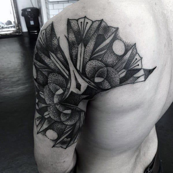 Black and white geometric tattoo featuring abstract shapes and patterns, with a combination of circles, sharp lines, and intricate shading, creating a dynamic and modern design.