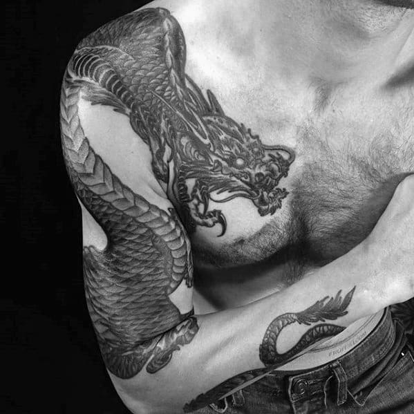 Arm And Shoulder Tattoo Of Dragon On Male