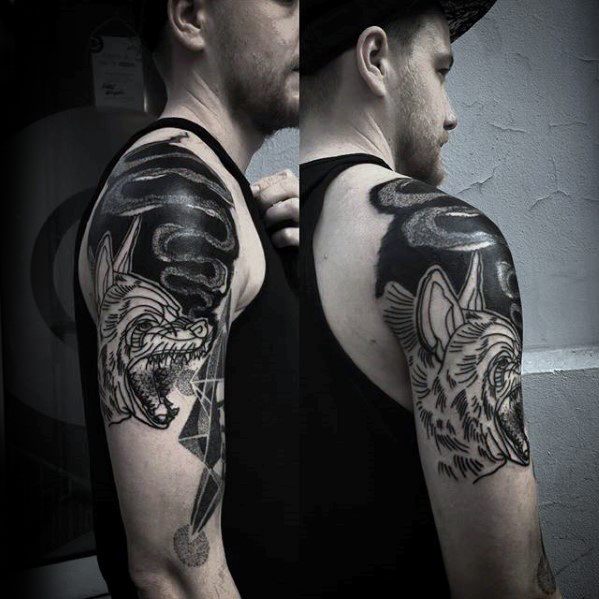 Bold blackwork hyena tattoo on the upper arm, featuring aggressive expression, lightning bolts, and swirling dark smoke patterns.
