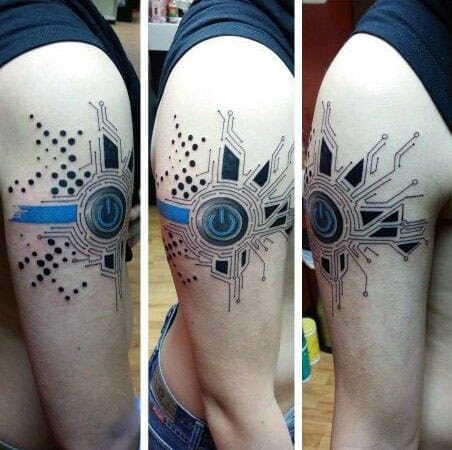 Futuristic power button tattoo on the upper arm with circuit board lines, dotwork, and a bold blue stripe across the design.