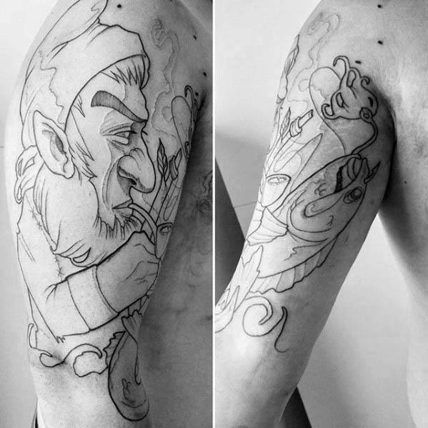 Black and grey outline tattoo of a leprechaun smoking a pipe, paired with a stylized fish mask design on the upper arm.