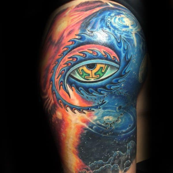 Colorful Tool-inspired tattoo featuring a central eye with tribal flames, cosmic swirls, and fire and water elements on the upper arm.