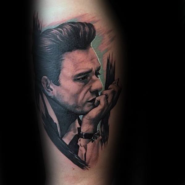 Tattoo of a pensive man with slicked-back hair, evoking the spirit of Johnny Cash