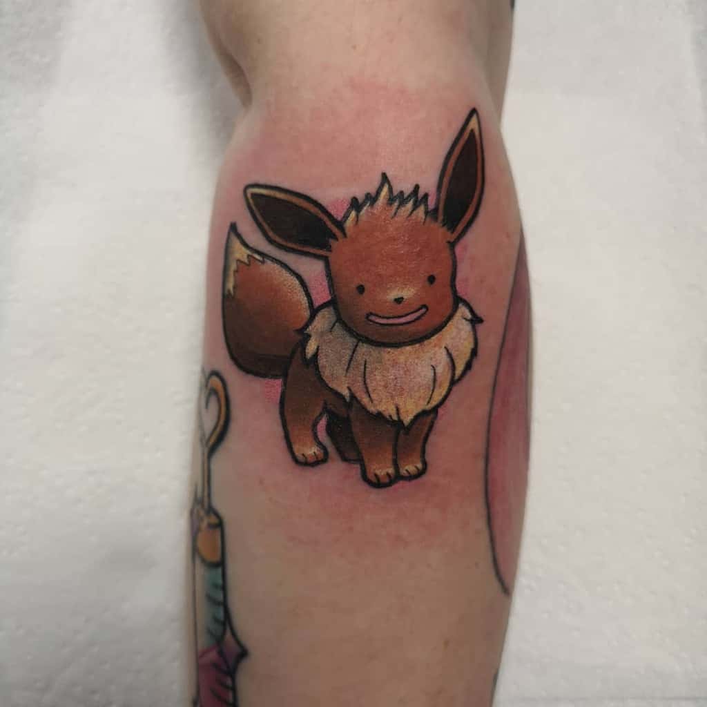 Minimalist Eevee tattoo with a cute and simplified face, featuring soft shading and a playful charm