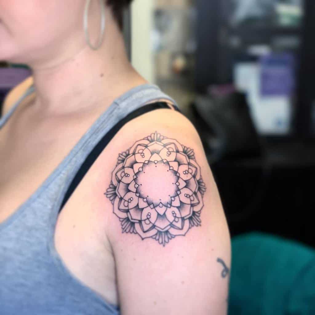 Woman with a mandala tattoo on her upper arm