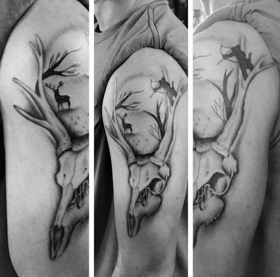 Black and white deer skull tattoo with forest scene inside antlers, showing a bowhunter aiming at a buck under a full moon.
