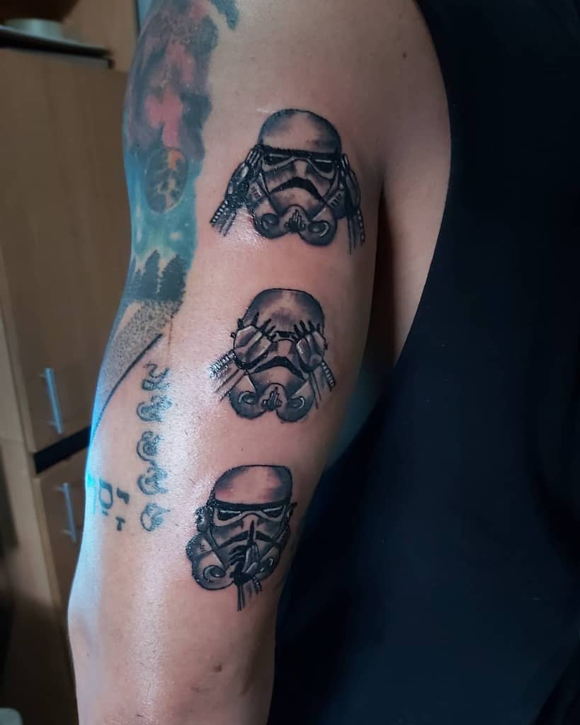 Arm tattoo of three Stormtrooper helmets representing 'Hear No Evil, See No Evil, Speak No Evil,' with bold black shading