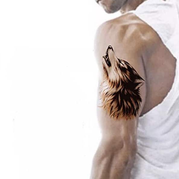 Striking tattoo of a majestic, howling wolf on man's upper arm