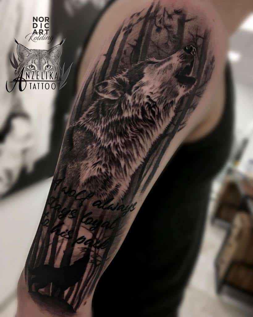 A captivating tattoo of a lone wolf howling in a dense forest graces the arm