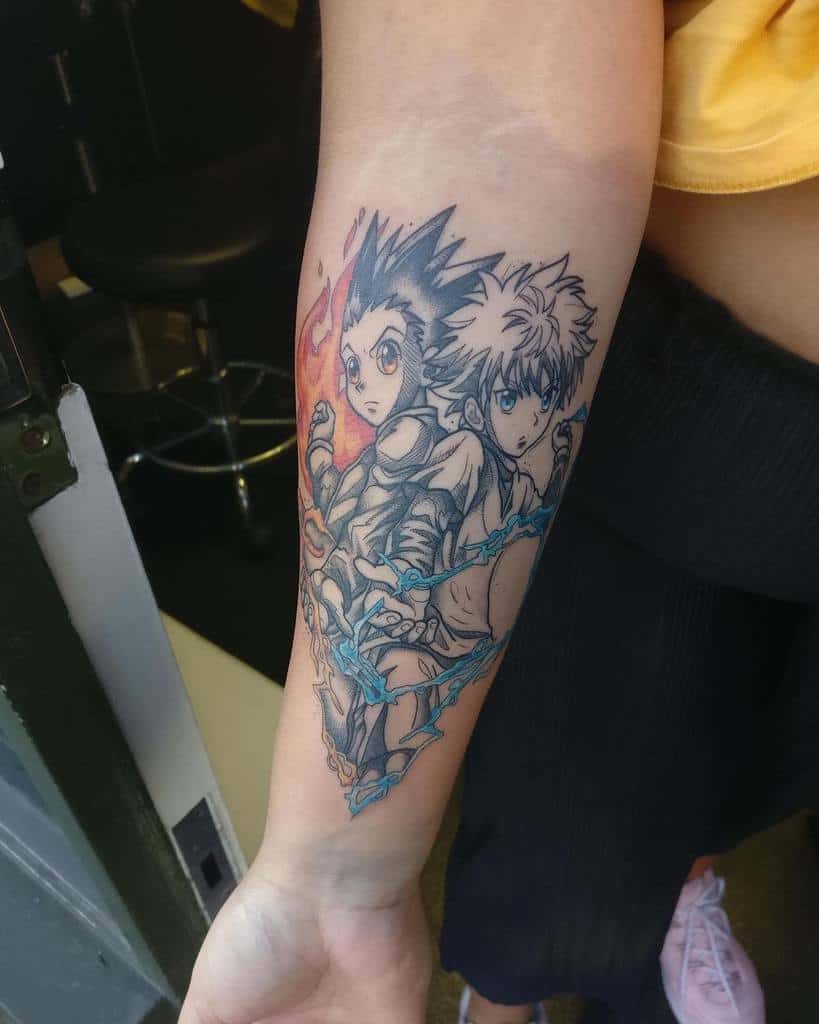 Colorful forearm tattoo of Gon and Killua from Hunter x Hunter, showcasing their fiery and electric powers in a dynamic design