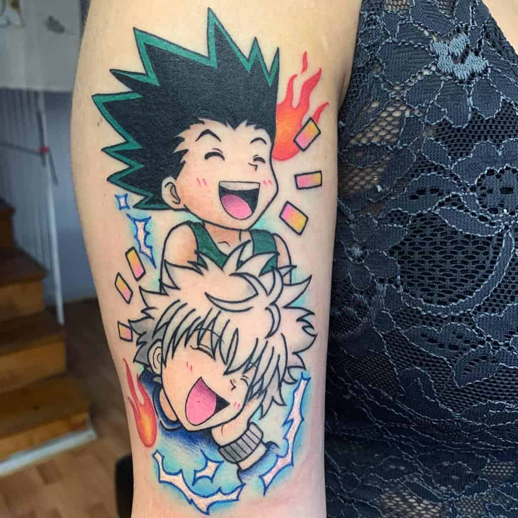 Vibrant tattoo of Gon and Killua from Hunter x Hunter, showcasing their joyful expressions with colorful fiery and electric details