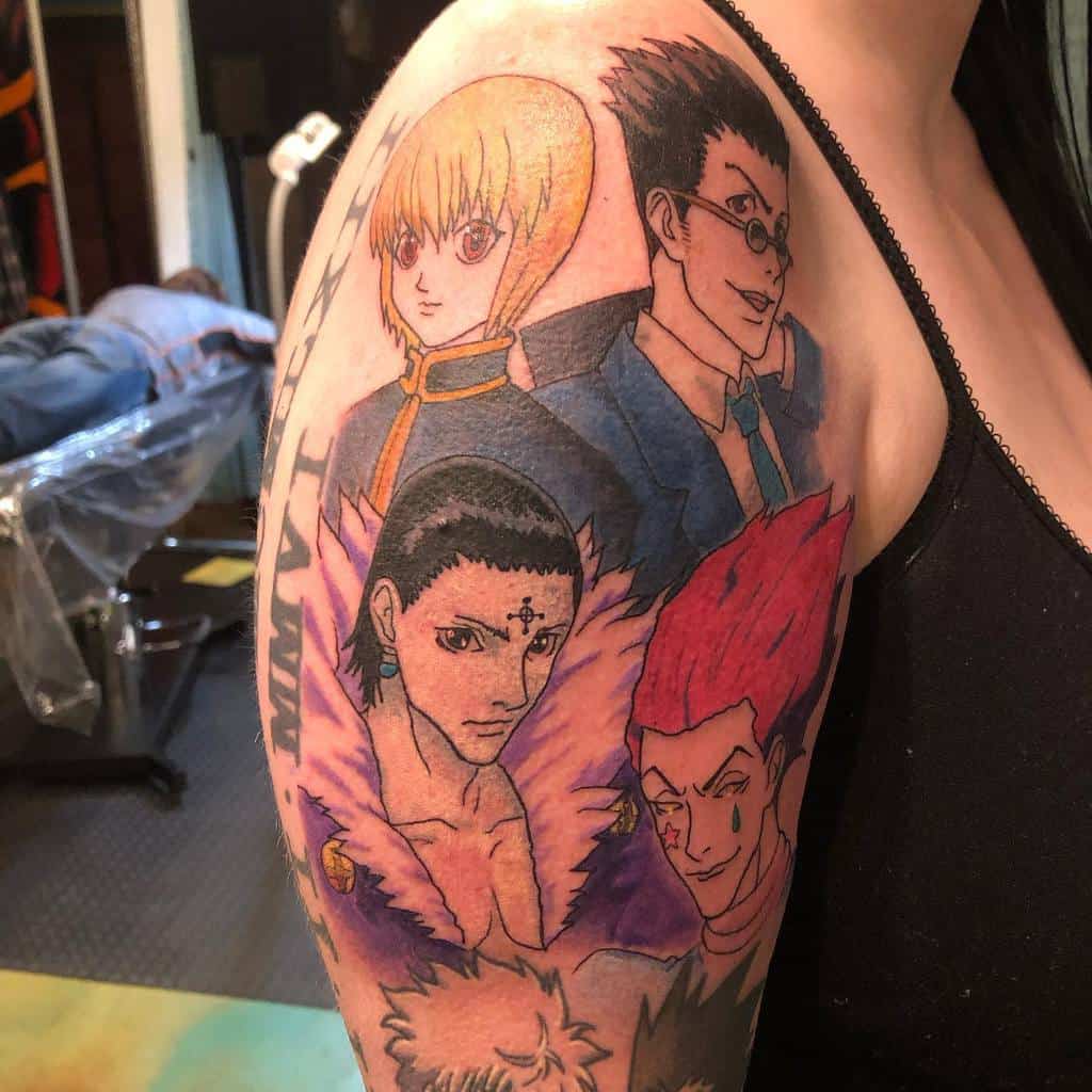 Vibrant upper arm tattoo featuring Hunter x Hunter characters Kurapika, Gon, Chrollo, Hisoka, and Killua in a colorful and detailed composition
