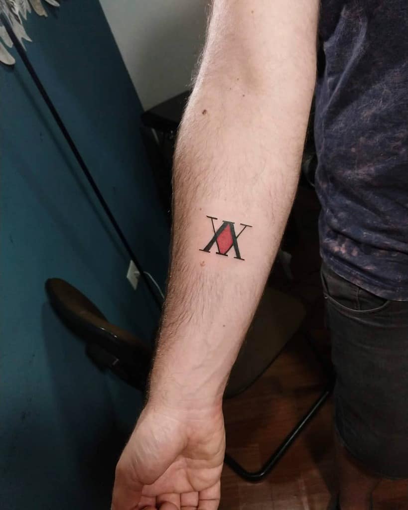 Simple forearm tattoo of the Roman numeral XVII with a red diamond, symbolizing Hunter x Hunter's Phantom Troupe member