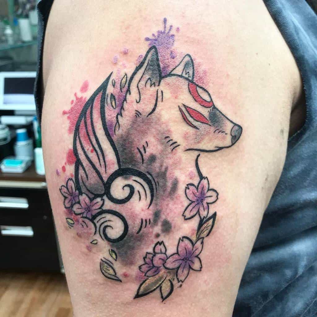Tattoo of a stylized wolf with swirling elements, pink flowers, and Japanese influences on an upper arm