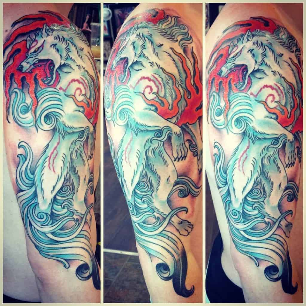 Arm tattoo featuring a stylized Japanese wolf with swirling red and blue elements