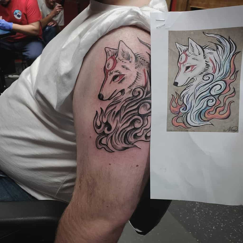 Tattoo of a stylized Japanese wolf with swirling fur designs and a red marking on its forehead, placed on the upper arm