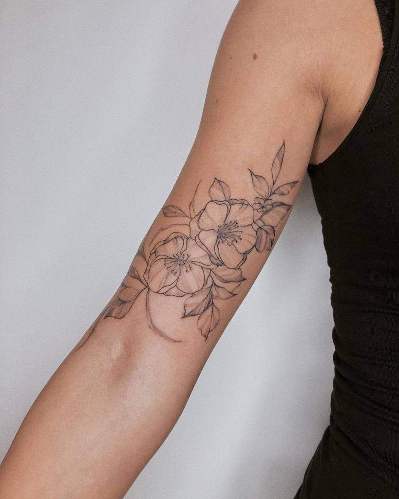 Arm with a detailed jasmine floral tattoo design