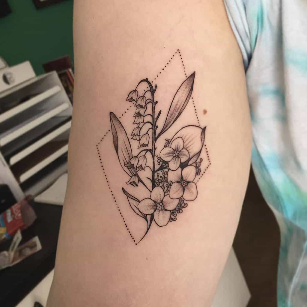 Fine-line floral tattoo featuring Lily of the Valley and hydrangeas, framed by a dotted geometric design
