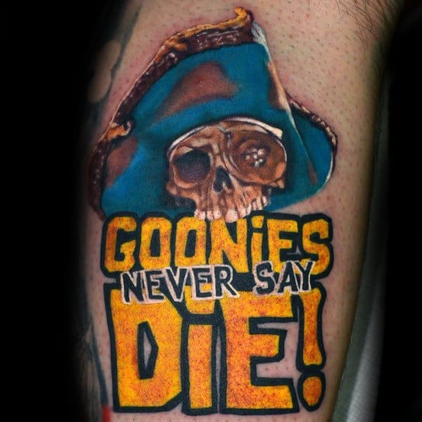 Colorful tattoo of One-Eyed Willy from The Goonies wearing a pirate hat, with bold yellow text reading "Goonies Never Say Die!".