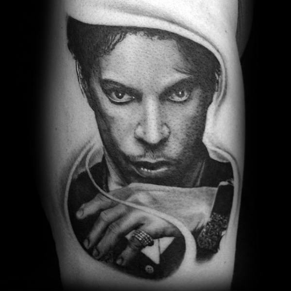 Portrait tattoo of a Prince with intense eyes and curled hand