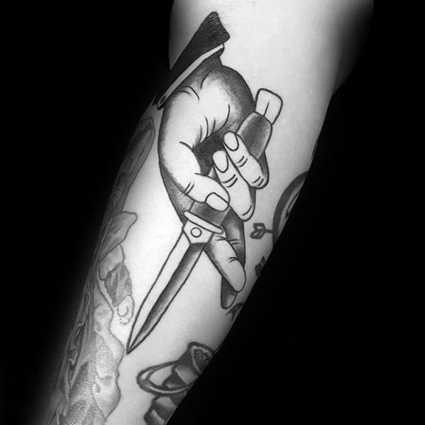 Arm Mens Hand Holding Switchblade Tattoo Design Inspiration