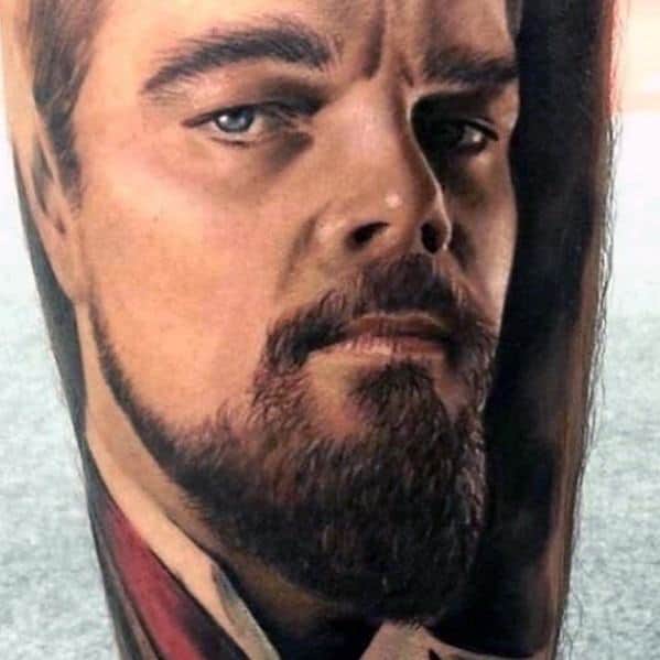 Hyper-realistic tattoo of actor Leonardo DiCaprio, showcasing his intense gaze and detailed facial features