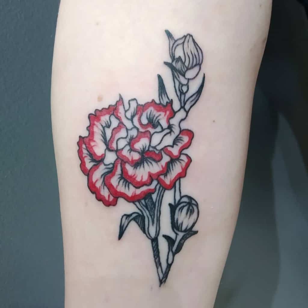 Tattoo of a blooming carnation with red and black outlines, featuring a stem and two buds