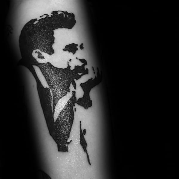 Black and white tattoo of Johnny Cash whispering on an arm