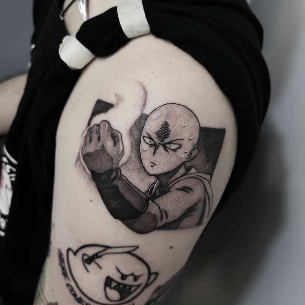 A black and gray tattoo of Saitama from One Punch Man in a serious battle pose, with shading and smoke effects on the arm