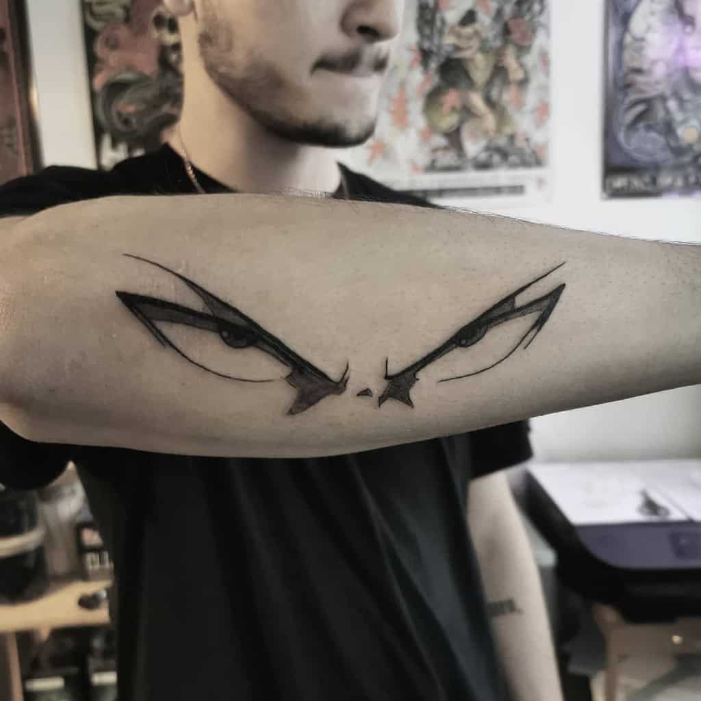 A minimalist black ink tattoo of Saitama's intense eyes from One Punch Man on a person's forearm, capturing his serious gaze