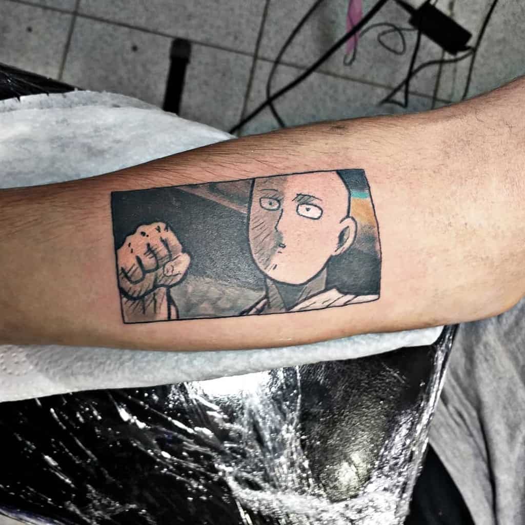 A tattoo of Saitama from One Punch Man in his signature blank expression, framed in a manga panel style, with his fist raised
